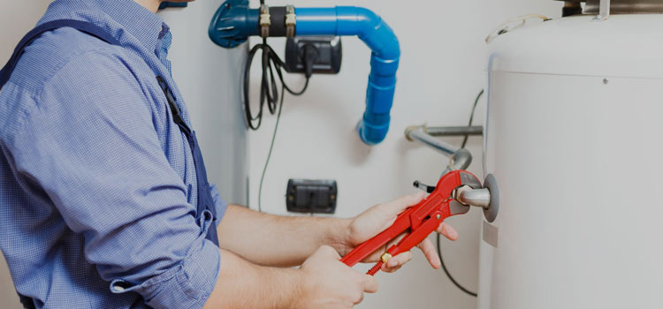 Technician repairing water heater in Dubai home